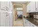 Bright kitchen shows white cabinets, granite countertops, and stainless hardware at 17675 N Coconino Dr, Surprise, AZ 85374