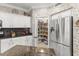 Bright kitchen showcases white cabinets, granite countertops, stainless fridge, and walk-in pantry at 17675 N Coconino Dr, Surprise, AZ 85374