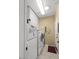 Functional laundry area with modern appliances, storage cabinets, and a doorway at 17675 N Coconino Dr, Surprise, AZ 85374