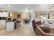 Open concept living area featuring tile flooring, comfortable seating, and a kitchen bar at 17675 N Coconino Dr, Surprise, AZ 85374