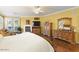 Bright bedroom showcasing a fireplace, dresser, sitting area and a ceiling fan at 17675 N Coconino Dr, Surprise, AZ 85374