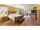 Bedroom with a king bed, ceiling fan and a comfortable seating area with a fireplace at 17675 N Coconino Dr, Surprise, AZ 85374