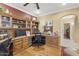 Spacious home office with wood floors, custom built-ins, and ample workspace at 17675 N Coconino Dr, Surprise, AZ 85374