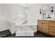 A modern bathroom showcasing a marble tub, contemporary chandelier, and sleek vanity with a vessel sink at 18344 W Santa Irene Dr, Goodyear, AZ 85338