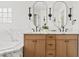 Bathroom featuring dual sinks, modern fixtures, and ample cabinet space, accented with stylish mirrors at 18344 W Santa Irene Dr, Goodyear, AZ 85338