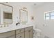 Bright bathroom featuring elegant mirrors, modern fixtures, dual sinks, and ample counter space at 18344 W Santa Irene Dr, Goodyear, AZ 85338