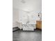 Light-filled bathroom featuring a marble-clad tub, walk-in shower, stylish vanity, and modern chandelier at 18344 W Santa Irene Dr, Goodyear, AZ 85338