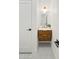 Modern bathroom features a decorative mirror and a floating vanity with elegant fixtures and gray mosaic tile floor at 18344 W Santa Irene Dr, Goodyear, AZ 85338