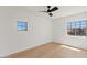 This bedroom offers plenty of natural light, light wood floors and a modern ceiling fan at 18344 W Santa Irene Dr, Goodyear, AZ 85338
