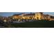 Elegant clubhouse exterior with well-manicured lawns, landscape lighting, and lush landscaping at 18344 W Santa Irene Dr, Goodyear, AZ 85338