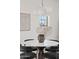 Dining room showcasing a modern light fixture over a round table with stylish black chairs at 18344 W Santa Irene Dr, Goodyear, AZ 85338