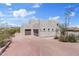 Exterior view of a Southwestern home showing the garage, driveway, and desert landscaping at 18344 W Santa Irene Dr, Goodyear, AZ 85338