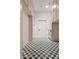 Hallway features checkered floors, many storage cabinets and a laundry area at 18344 W Santa Irene Dr, Goodyear, AZ 85338