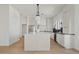 Modern kitchen with white cabinets, stainless steel appliances, and a large center island at 18344 W Santa Irene Dr, Goodyear, AZ 85338