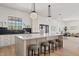 Bright, open kitchen features a large island with marble countertop and stylish pendant lighting at 18344 W Santa Irene Dr, Goodyear, AZ 85338
