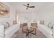 Bright living room featuring modern furniture, a stylish rug, and a contemporary ceiling fan at 18344 W Santa Irene Dr, Goodyear, AZ 85338