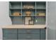 Charming mudroom featuring custom cabinetry, built-in shelving, and stylish decor, creating an organized and inviting space at 18344 W Santa Irene Dr, Goodyear, AZ 85338