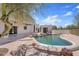 Backyard features a unique pool design, beautiful landscaping and a view of the home at 18344 W Santa Irene Dr, Goodyear, AZ 85338