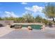Backyard features a unique pool design, beautiful landscaping, and a desert view at 18344 W Santa Irene Dr, Goodyear, AZ 85338