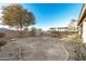 Large backyard with a perimeter of trees, a block wall fence, and a gravel border at 22500 N Greenland Park Dr, Maricopa, AZ 85139