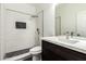 Modern bathroom featuring a dark wood vanity with a white countertop and a tiled shower with a glass partition at 22500 N Greenland Park Dr, Maricopa, AZ 85139