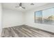 This bedroom offers a large window and modern floors, creating a bright and stylish space at 22500 N Greenland Park Dr, Maricopa, AZ 85139