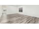 Sunlit bedroom with vinyl plank flooring, neutral walls, and a large window for ample natural light at 22500 N Greenland Park Dr, Maricopa, AZ 85139