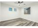 Spacious bedroom with modern floors and dual windows, offers a bright and airy atmosphere at 22500 N Greenland Park Dr, Maricopa, AZ 85139