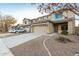 Two-story home with wide driveway, desert landscaping and a neutral color palette in a suburban neighborhood at 22500 N Greenland Park Dr, Maricopa, AZ 85139