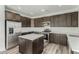 Updated kitchen with stainless steel appliances, central island, and ample storage space at 22500 N Greenland Park Dr, Maricopa, AZ 85139