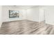 Bright living room with modern vinyl plank flooring, neutral walls, and a large window for natural light at 22500 N Greenland Park Dr, Maricopa, AZ 85139