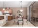 Cozy dining area with a glass-top table, decorative lighting, and sliding glass door at 2600 E Springfield Pl # 61, Chandler, AZ 85286
