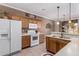 Well-equipped kitchen with white appliances, wood cabinets, and a breakfast bar at 2600 E Springfield Pl # 61, Chandler, AZ 85286