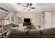Comfortable living room with large windows, plush seating, and a ceiling fan at 2600 E Springfield Pl # 61, Chandler, AZ 85286