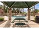 Community pool area with picnic table under a shaded awning and surrounded by palm trees at 2600 E Springfield Pl # 61, Chandler, AZ 85286