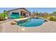 Inviting backyard pool with a rock waterfall feature and a covered patio area for relaxing at 2662 S Iowa St, Chandler, AZ 85286
