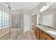 This bathroom offers a glass shower enclosure, granite counters, and tiled flooring at 2662 S Iowa St, Chandler, AZ 85286