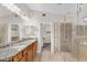 Bright bathroom features dual sinks with granite counters and a large glass-enclosed shower at 2662 S Iowa St, Chandler, AZ 85286