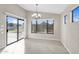 Dining room with tile flooring, modern chandelier and sliding doors to the backyard at 2662 S Iowa St, Chandler, AZ 85286