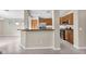 Spacious kitchen featuring stainless appliances, wooden cabinetry and tiled floors at 2662 S Iowa St, Chandler, AZ 85286