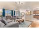 Open-concept living room with a large sectional, hardwood floors, and access to the kitchen at 2662 S Iowa St, Chandler, AZ 85286