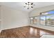 Bright and airy living room with large windows, hardwood floors, and a ceiling fan at 2662 S Iowa St, Chandler, AZ 85286