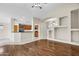 Open living space featuring hardwood floors, a breakfast bar, and a view to the kitchen at 2662 S Iowa St, Chandler, AZ 85286