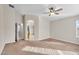 Neutral main bedroom featuring a ceiling fan and ensuite bath at 2662 S Iowa St, Chandler, AZ 85286