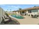 Inviting backyard features a private pool, lounge area, and manicured lawn at 307 W Alamo Dr, Chandler, AZ 85225