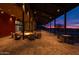 Inviting outdoor patio area with fire pit, seating, and sunset views at 32553 N 133Rd Ave, Peoria, AZ 85383