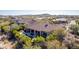 Aerial view of a home with a tile roof, pool, and desert landscaping at 37267 Ne Greythorn Cir, Carefree, AZ 85377