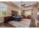 Serene primary bedroom showcasing a decorative rug, tray ceilings, and a ceiling fan at 37267 Ne Greythorn Cir, Carefree, AZ 85377