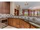 Stylish wet bar with decorative tile backsplash and wood cabinetry at 37267 Ne Greythorn Cir, Carefree, AZ 85377