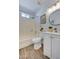 Well-lit bathroom featuring a shower and tub combo, along with a stylish sink and vanity at 3728 E Grove Ave, Mesa, AZ 85206